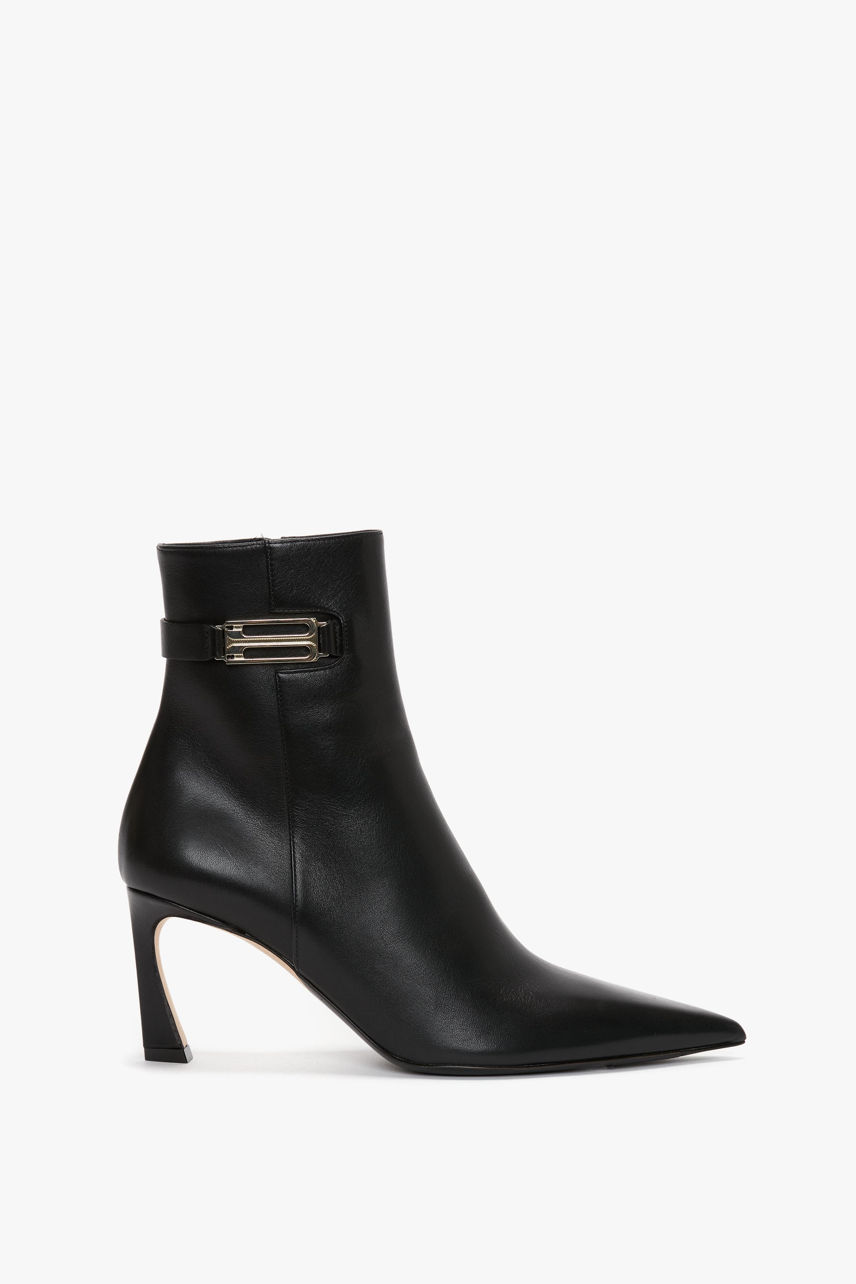 Victoria Beckham's Pointed Toe Half Boot in Black Soft Calf Leather features a pointed toe, a mid-height sculptural stiletto heel, and a buckle strap detail around the ankle.