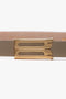 A close-up of the Exclusive Micro Frame Belt In Beige Leather by Victoria Beckham, featuring a gold rectangular buckle with two parallel cutouts.