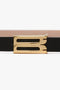 Close-up of a Victoria Beckham Exclusive Micro Frame Belt in black leather with a gold buckle against a white background.