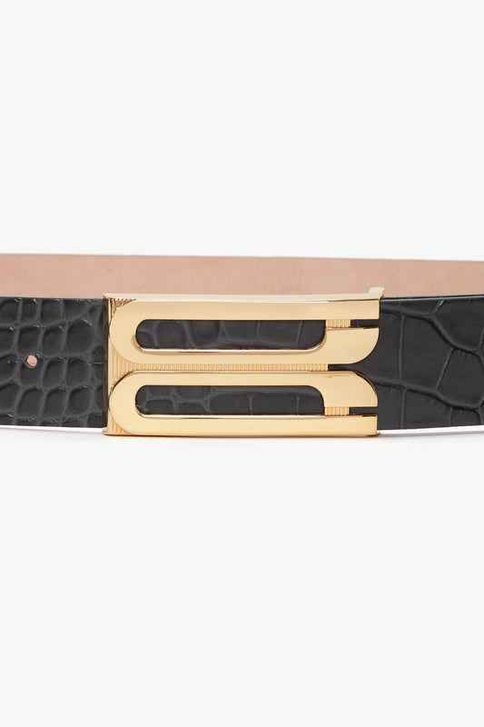 Victoria Beckham's Jumbo Frame Belt In Slate Grey Croc Embossed Calf Leather with a gold rectangular buckle featuring a unique cutout design.