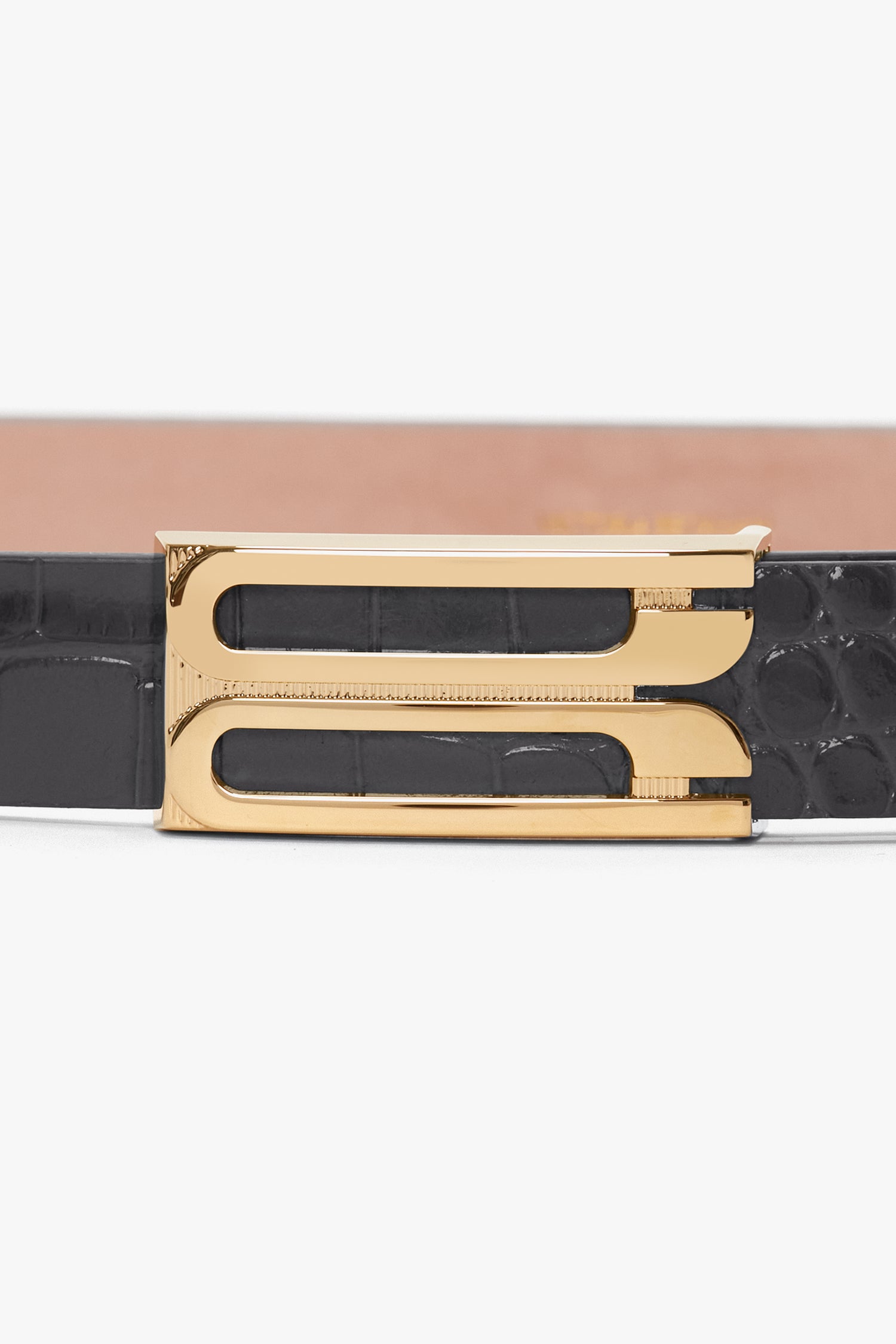 Close-up of a Victoria Beckham Frame Belt In Slate Grey Croc Embossed Calf Leather with gold hardware, featuring a unique double rectangular buckle design.
