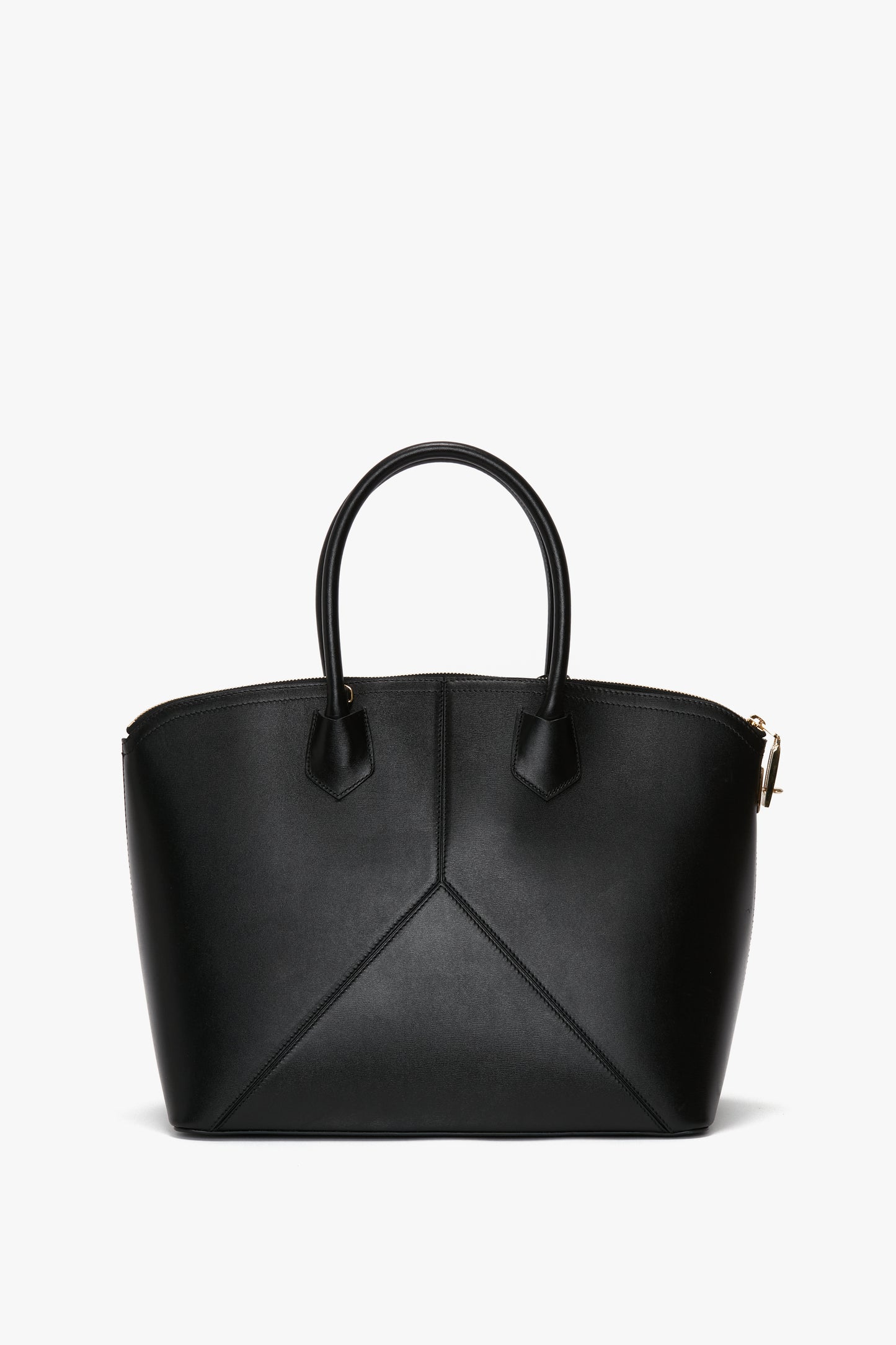 The Victoria Beckham Victoria Bag In Black Leather is a black leather handbag with two handles, featuring a structured design and elegant gold-tone hardware. This versatile hold-all includes refined leather panels, making it perfect for any occasion.