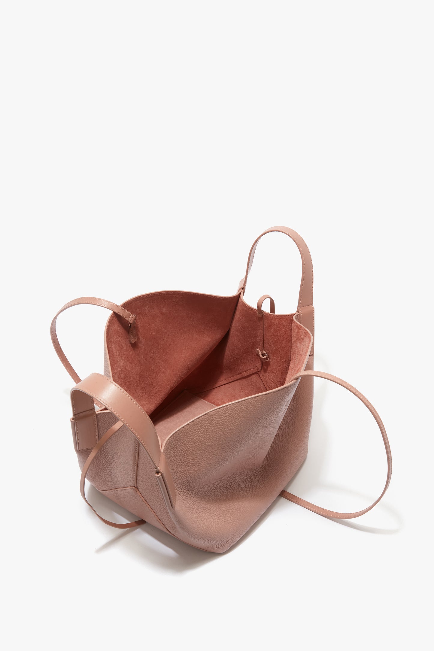 Open, light pink calf leather W11 Mini Tote Bag In Marshmallow Leather by Victoria Beckham with two handles and an unlined, spacious interior.