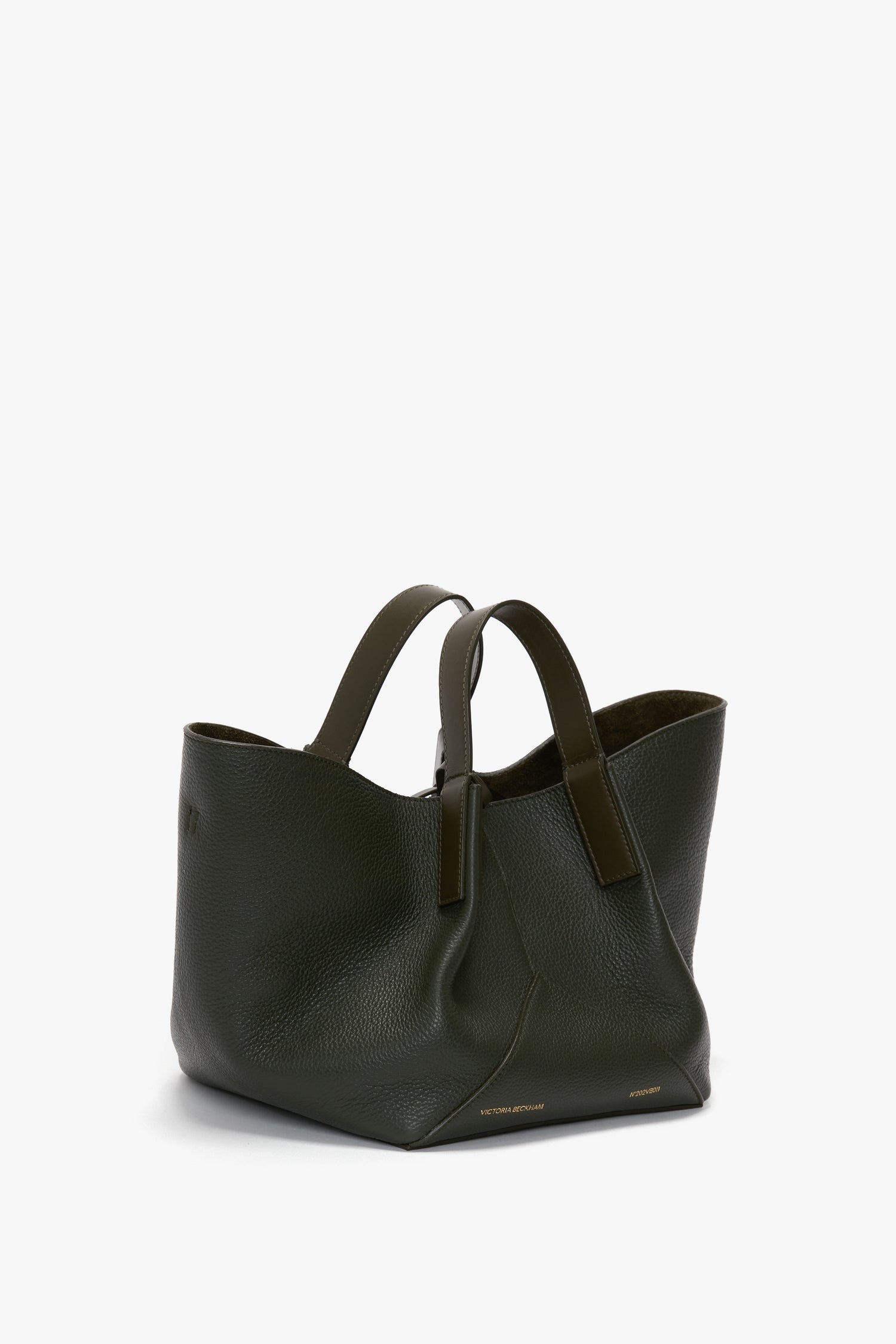 W11 Mini Tote Bag In Loden Leather by Victoria Beckham, with two handles, featuring a smooth texture and a minimalist design.