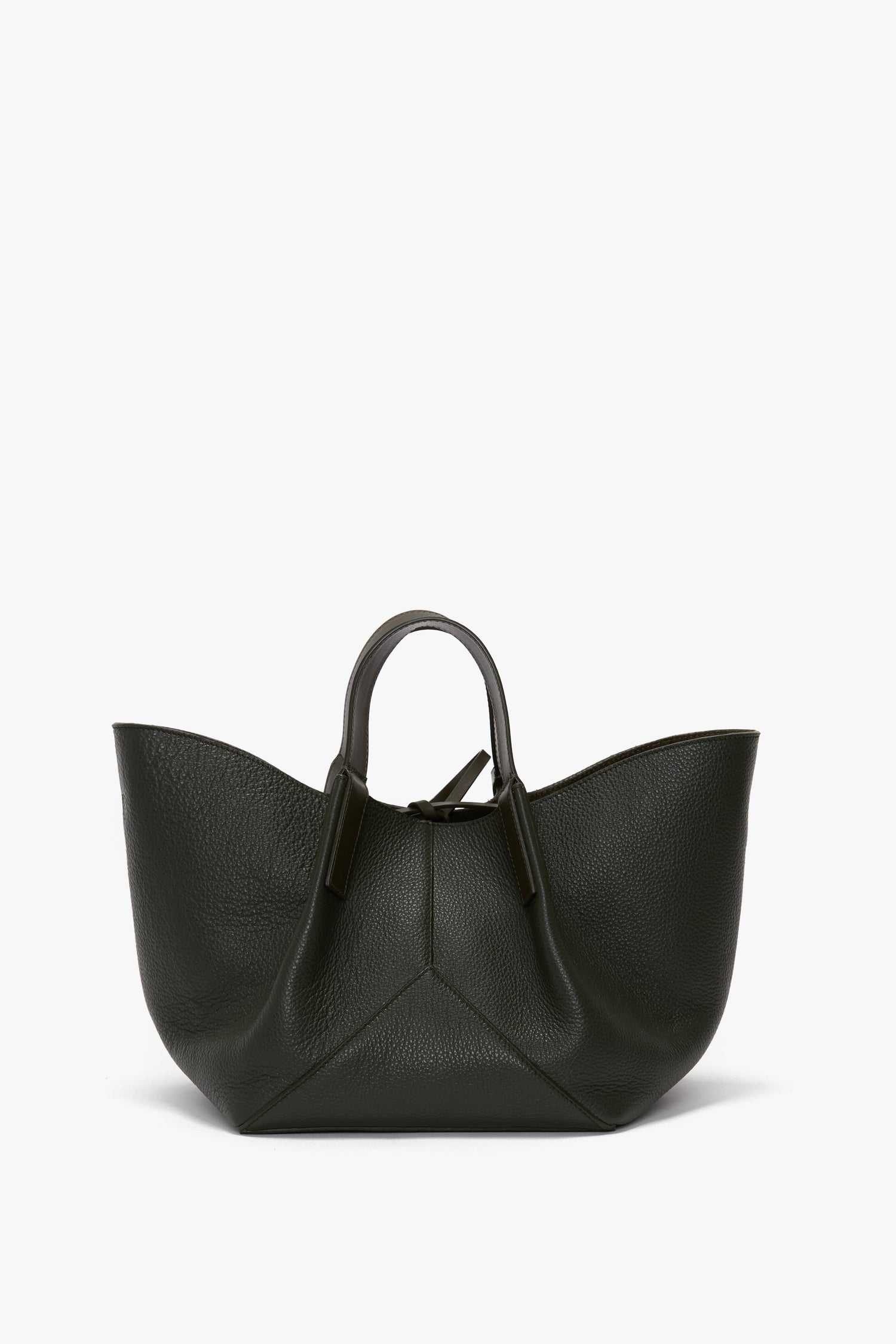 A W11 Mini Tote Bag In Loden Leather by Victoria Beckham with a minimalist design, featuring a wide opening, a triangular bottom, and short handles.