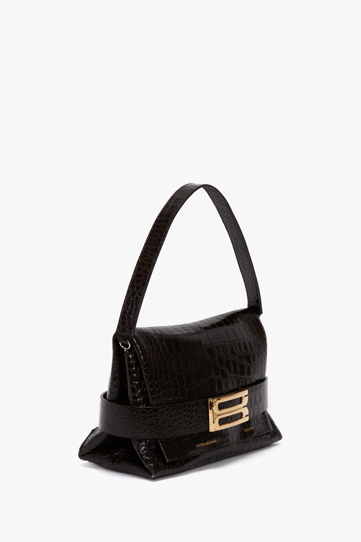 A small black leather **B Pouch Bag In Croc Effect Espresso Leather** by **Victoria Beckham**, with an embossed crocodile print, gold buckle detail, a single handle, and a detachable shoulder strap.