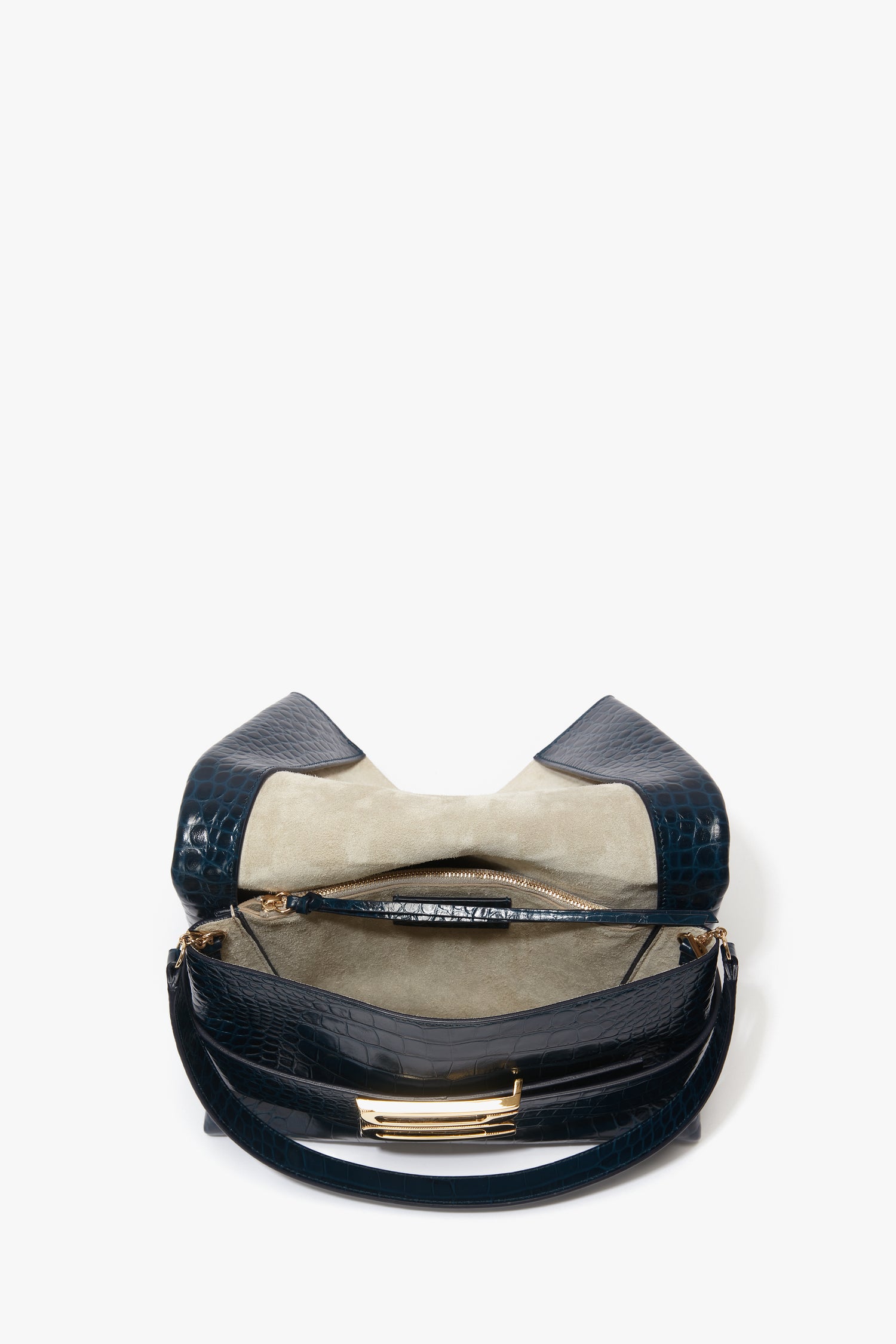 Open the B Pouch Bag In Croc Effect Midnight Blue Leather by Victoria Beckham, revealing an inner-lined pocket and zipper compartment. Comes with a detachable shoulder strap.