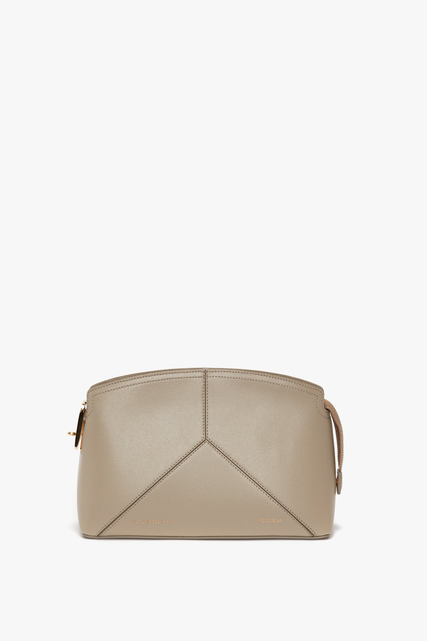 A Victoria Crossbody Bag In Taupe Leather by Victoria Beckham, featuring a minimalist structured design with a central seam and gold-tone zipper closure, inspired by Victoria Beckham's signature style.