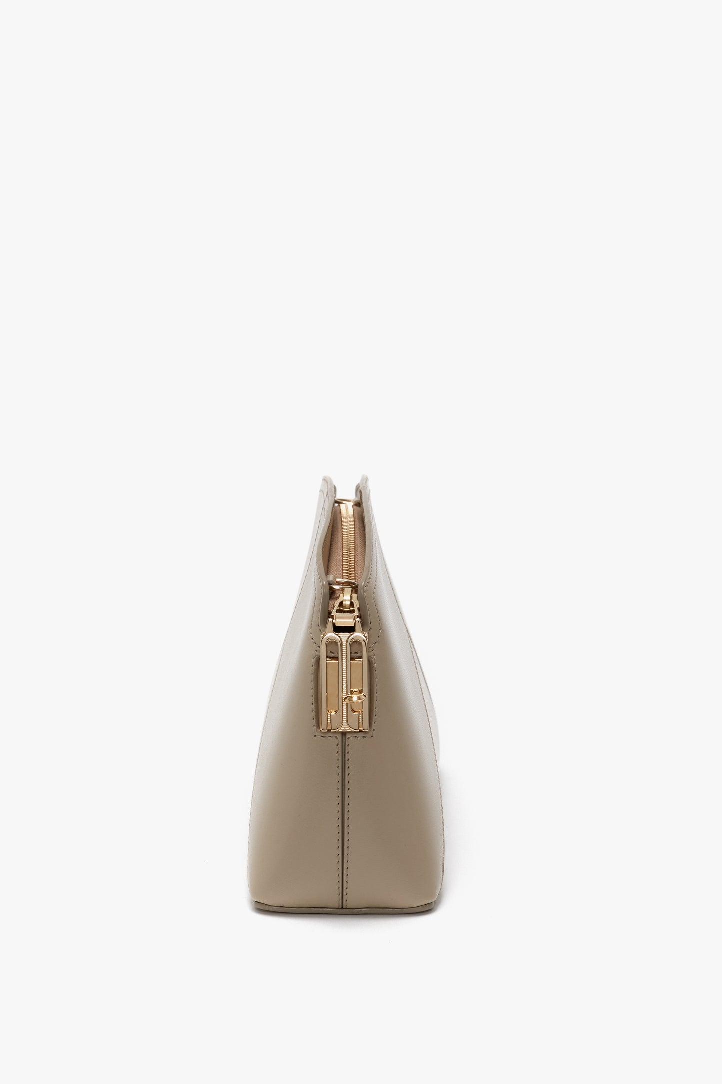 Side view of a Victoria Beckham Victoria Crossbody Bag In Taupe Leather with gold hardware against a white background.