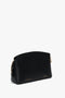 Black textured calf leather handbag with a gold zipper and "Victoria Beckham" logo embossed on the front. Features an adjustable strap for versatile wear, making it a perfect Victoria Beckham **Victoria Crossbody Bag In Black Leather** option.