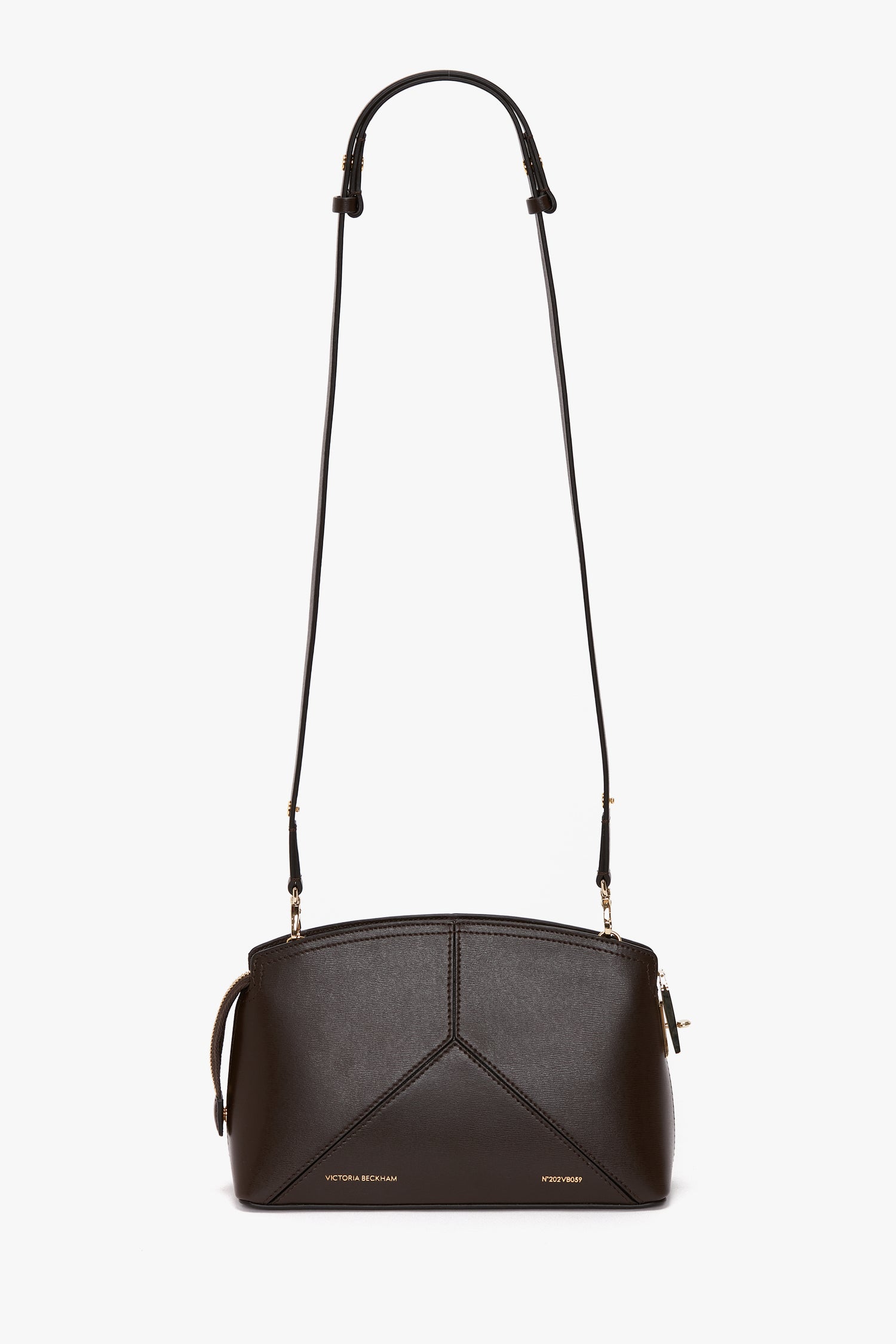 The Exclusive Victoria Crossbody Bag In Brown Leather by Victoria Beckham, crafted from sumptuous calf leather, features gold accents, an adjustable shoulder strap, and intricate geometric stitching detail.