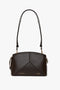 An Exclusive Victoria Crossbody Bag In Brown Leather, featuring an adjustable strap and labeled with "Victoria Beckham" and "PSFW 5007".