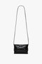 A Victoria Beckham Mini B Pouch Bag In Croc Effect Black Leather with an embossed crocodile print and a long shoulder strap.