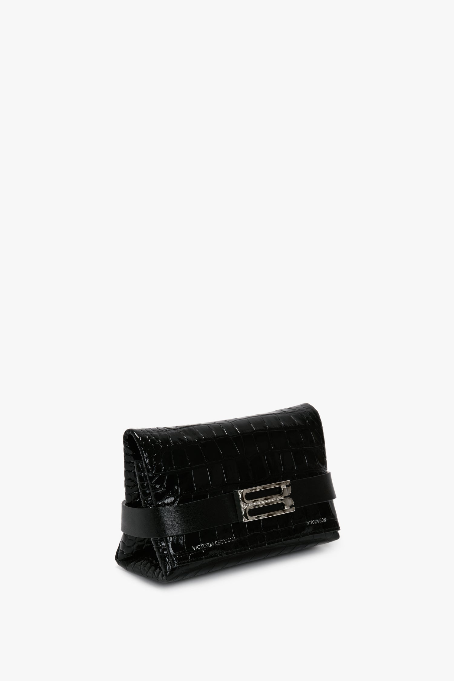 A textured black Victoria Beckham Mini B Pouch Bag In Croc Effect Black Leather with a rectangular metallic clasp and an embossed crocodile print, placed against a plain, white background.