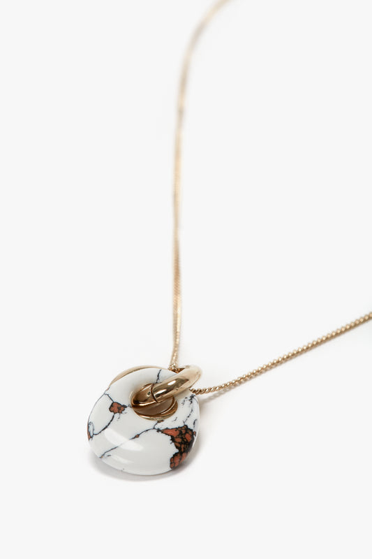 Introducing the **Exclusive Resin Pendant Necklace In Light Gold-White** by **Victoria Beckham**: A Light Gold/White chain necklace with a 31cm-long chain and a stunning resin pendant featuring brown and black marbled patterns.