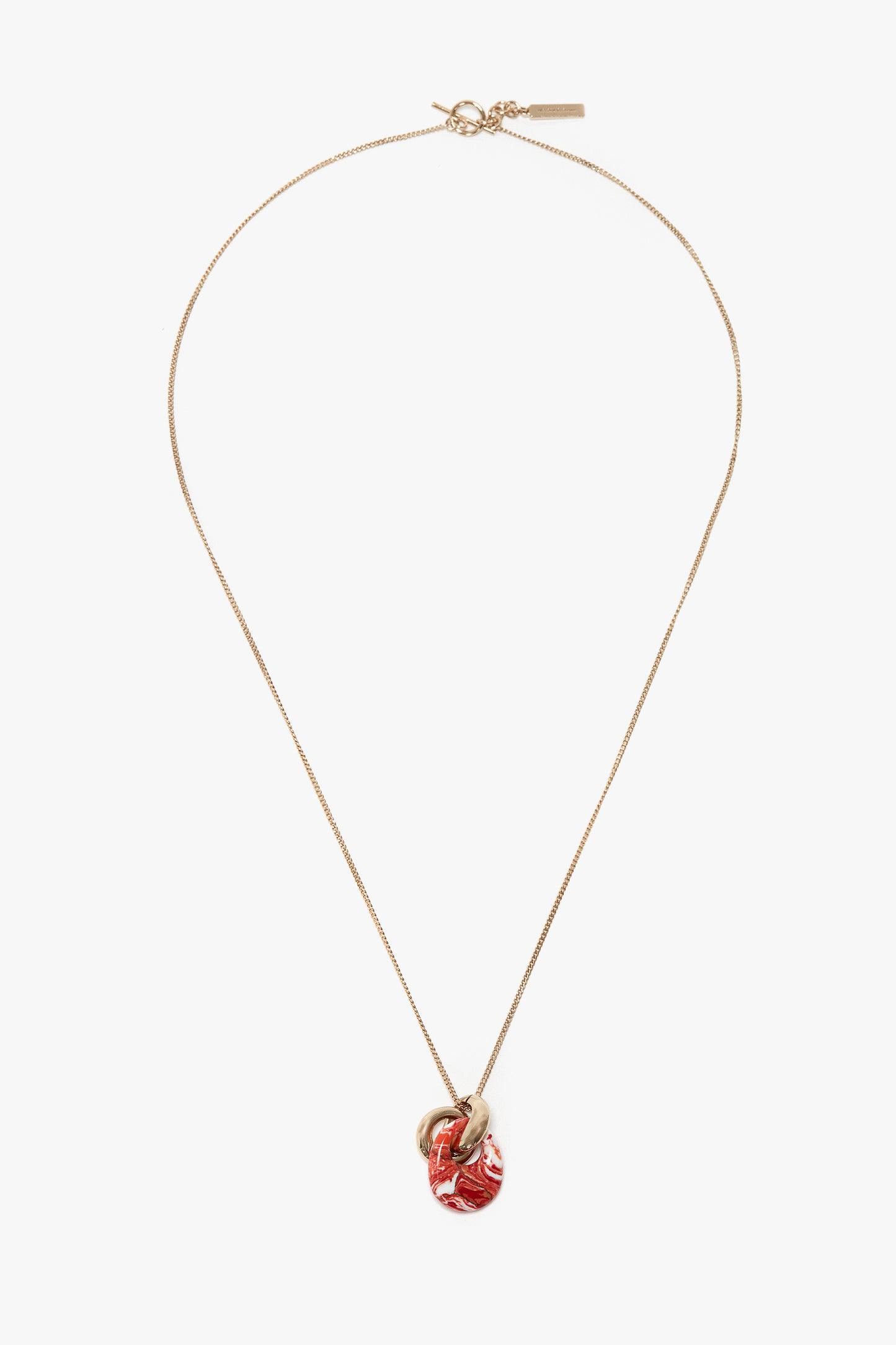 A 100% brass necklace with a fine chain, featuring a striking Light Gold/Orange resin pendant, the Exclusive Resin Pendant Necklace In Light Gold-Orange by Victoria Beckham.