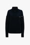 A Collar Detail Jumper In Navy by Victoria Beckham with ribbed detailing, exposed shoulder design, and chain stitch accents.