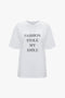 White, relaxed fit Victoria Beckham Fashion Stole My Smile Slogan T-Shirt In White made from organic cotton with the text "FASHION STOLE MY SMILE" printed in bold black uppercase letters on the front.