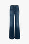 A pair of Victoria Beckham's Alina High Waisted Jean in Dark Vintage Wash, featuring blue, high-waisted, wide-leg jeans with front and back pockets, shown from the back.