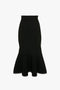 A black VB Body Scallop Trim Flared Skirt In Black by Victoria Beckham, featuring a high waist and a flattering flared silhouette with scalloped edges.