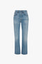 A pair of Victoria Mid-Rise Jean In Light Blue with a straight-leg cut, five pockets, and a classic button fly closure in the front made from washed denim by Victoria Beckham.