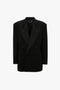 A Satin Lapel Tuxedo Jacket in Black by Victoria Beckham features satin lapels, satin-covered buttons, and two pockets.