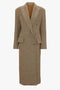 A long, relaxed modern fit brown tweed coat with wide lapels and two buttons, featuring two flap pockets from the Exclusive Waisted Tailored Coat In Flax by Victoria Beckham.