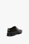 Single black brushed leather dress shoe with a pointy toe silhouette, viewed from behind on a white background. Product Name: Pointy Toe Flat Lace Up In Black Brushed Leather. Brand Name: Victoria Beckham.