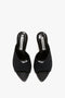 A pair of Victoria Beckham V Cut Mule In Black Raffia with a textured raffia upper material and a label inside the insole.