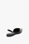 Black, croc embossed calf leather, pointed-toe flat shoe with a slingback strap and an asymmetric V cut, viewed from a back angle against a white background. This is the V Cut Sling Back In Black Croc-Effect Leather by Victoria Beckham.