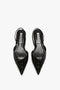 A pair of black, pointed-toe slingback flats with textured, croc-embossed calf leather uppers and an elegant asymmetric V cut, viewed from above on a white background. The shoes are the V Cut Sling Back In Black Croc-Effect Leather by Victoria Beckham.