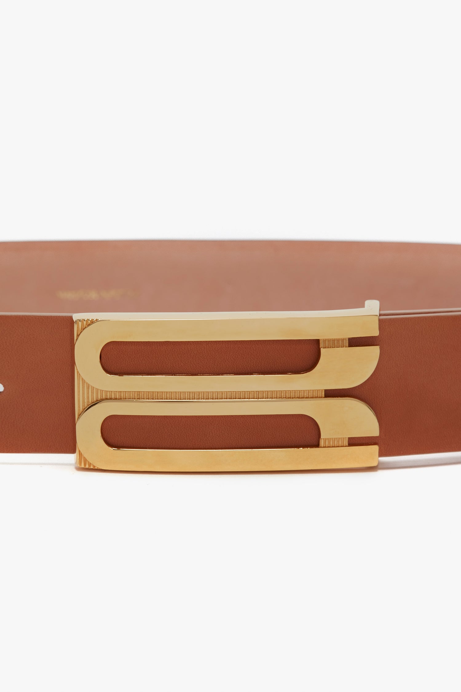 Brown **Victoria Beckham Exclusive Jumbo Frame Belt In Tan Leather** with a gold double-line buckle and smooth calf leather on a white background.