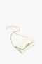 A small white Exclusive Wallet On Chain In Ivory Croc-Effect Leather with a gold chain strap and gold clasp, crafted from embossed croc leather by Victoria Beckham.