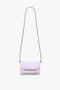 A Victoria Beckham Exclusive Mini Chain Pouch Bag With Long Strap In Lilac Leather with a long, thin detachable strap and gold chain detailing on the front.