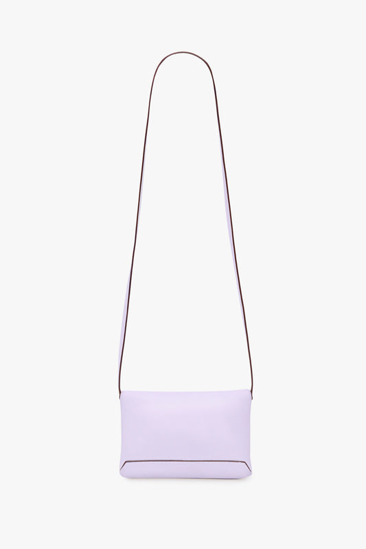 A Victoria Beckham EXCLUSIVE Mini Chain Pouch With Long Strap In Lilac Leather is displayed against a white background.