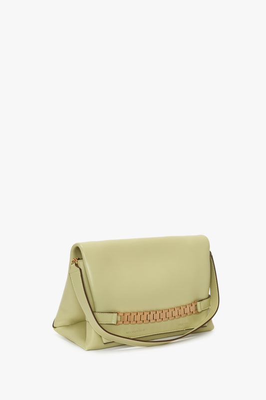 The Chain Pouch With Strap In Avocado Leather by Victoria Beckham features a fold-over flap and a woven accent near the base, complete with a single handle for effortless elegance.