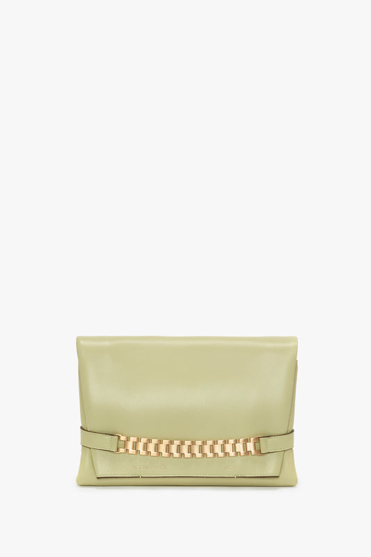 A rectangular, avocado light green Chain Pouch With Strap In Avocado Leather by Victoria Beckham with a gold chain detail on the front.
