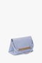 Light blue Chain Pouch With Strap In Frost Ostrich-Effect Leather by Victoria Beckham, featuring a rectangular gold accent in the middle and a single shoulder strap.