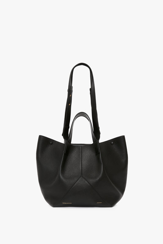 A W11 Medium Tote In Black Leather crafted by Victoria Beckham, featuring short handles and an adjustable shoulder strap for versatile styling.