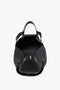 Open black Victoria Beckham W11 Medium Tote Bag In Black Leather with two top handles and a long shoulder strap, shown from a top-down view, revealing a spacious, empty interior.