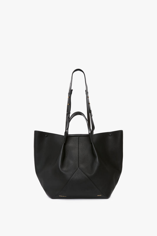 A large black W11 Jumbo Tote In Black Leather by Victoria Beckham with dual adjustable straps, subtle gold-tone hardware, and an internal pocket compartment.
