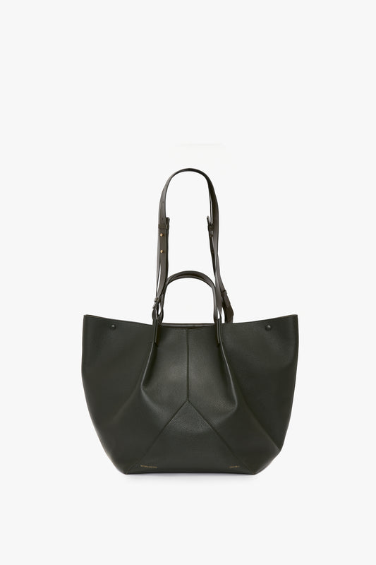 A luxury leather tote bag, the W11 Jumbo Tote In Loden Leather by Victoria Beckham, with an elegant V-shaped design, featuring two shoulder straps and a structured base, displayed on a white background.