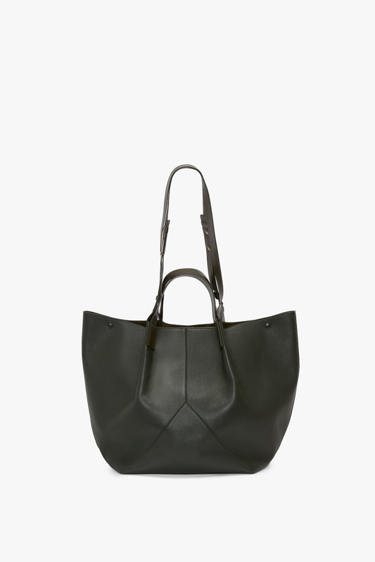 The W11 Jumbo Tote In Loden Leather by Victoria Beckham, featuring an elegant V-shaped design, two top handles, and a longer adjustable shoulder strap, is displayed against a plain white background.