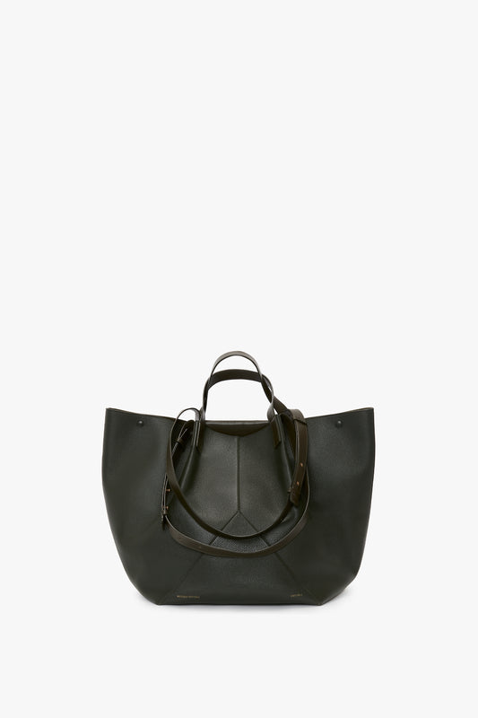A large, luxury W11 Jumbo Tote In Loden Leather by Victoria Beckham in elegant black, featuring two short handles and an optional long strap with adjustable straps. The sophisticated V-shaped design is displayed against a white background.
