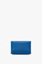 A Mini Chain Pouch Bag With Long Strap In Sapphire Blue by Victoria Beckham UK with a simple design against a white background, featuring a detachable strap.