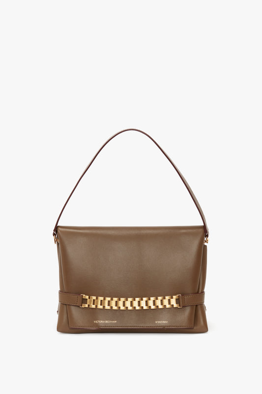 A khaki leather Chain Pouch Bag With Strap by Victoria Beckham UK, featuring a short shoulder strap, detachable strap option, and gold chain detail on the front.