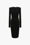 A Victoria Beckham Long Sleeve T-Shirt Fitted Dress In Black with a body-skimming silhouette and a high neckline, shown on a white background.