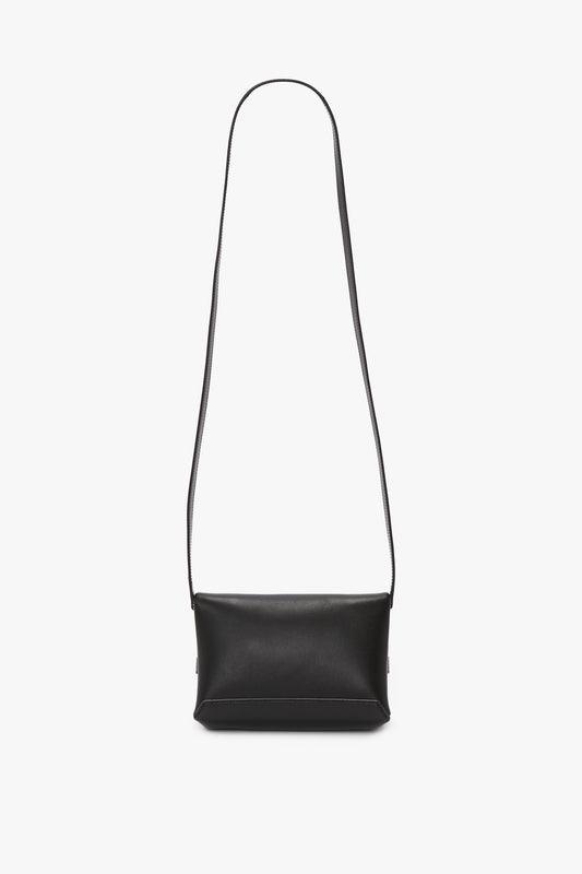 A Mini Chain Pouch With Long Strap In Black Leather by Victoria Beckham is centered against a plain white background.