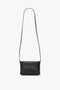 **Mini Chain Pouch Bag With Long Strap In Black Leather by Victoria Beckham**, crafted from luxurious lambskin leather, with a long strap, displayed on a plain white background.