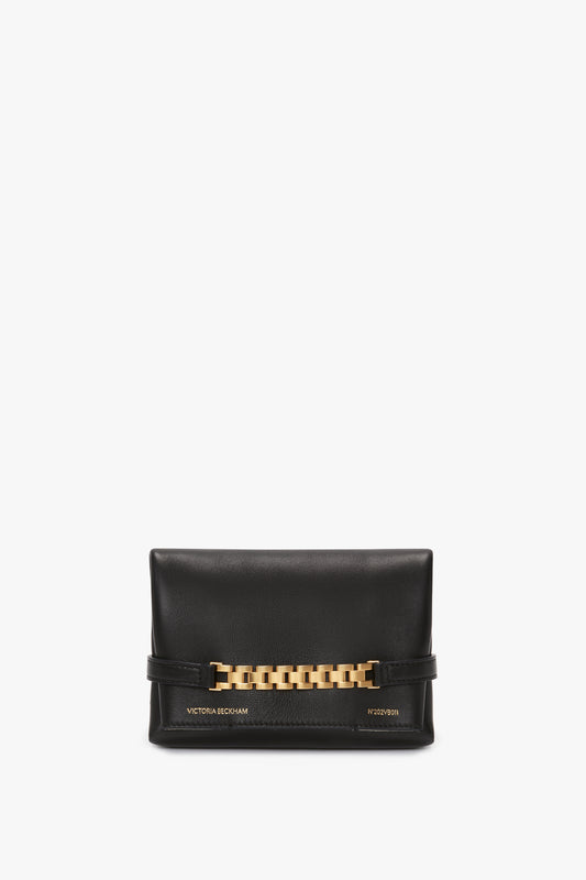 A Mini Chain Pouch With Long Strap In Black Leather featuring a gold-tone watch strap detail across the front, with "Victoria Beckham" and "1029621" embossed at the bottom.